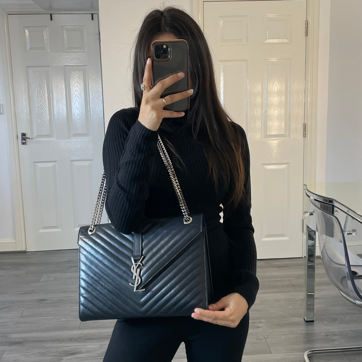 YSL designer black envelope bag modelled